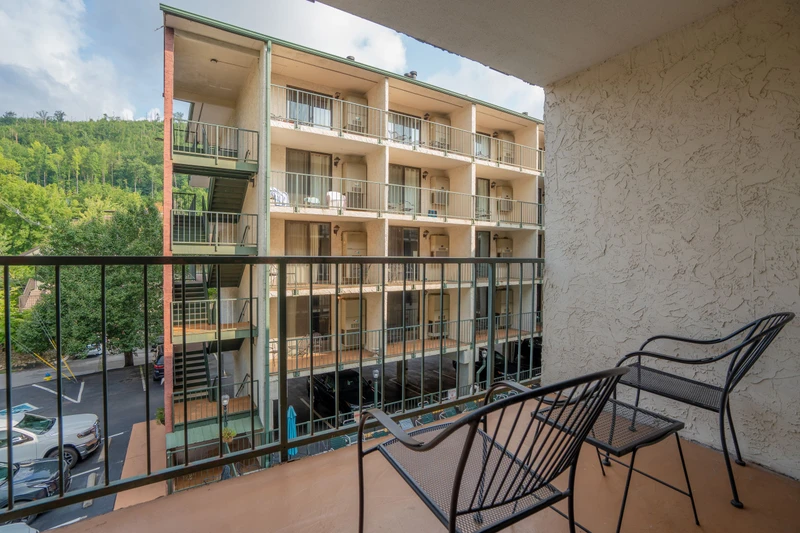 Step onto your private balcony and settle into the seating to take in views of the property and surrounding hillside. The peaceful setting offers a relaxing retreat after your mountain adventures.