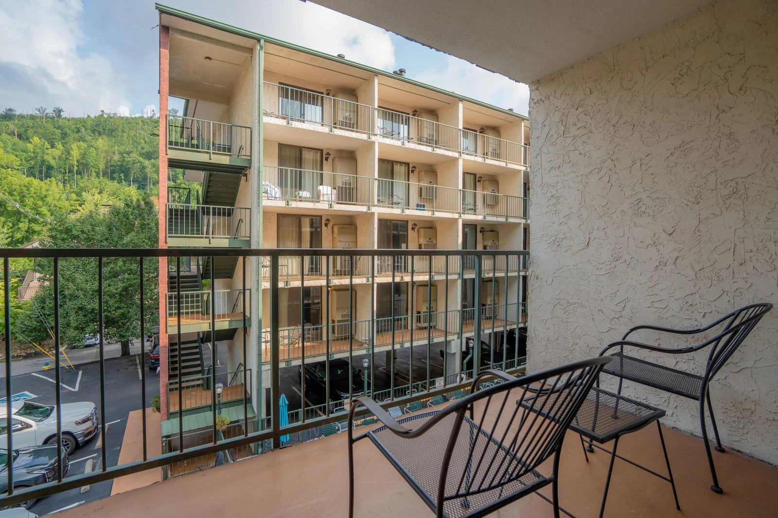 Step onto your private balcony and settle into the seating to take in views of the property and surrounding hillside. The peaceful setting offers a relaxing retreat after your mountain adventures.