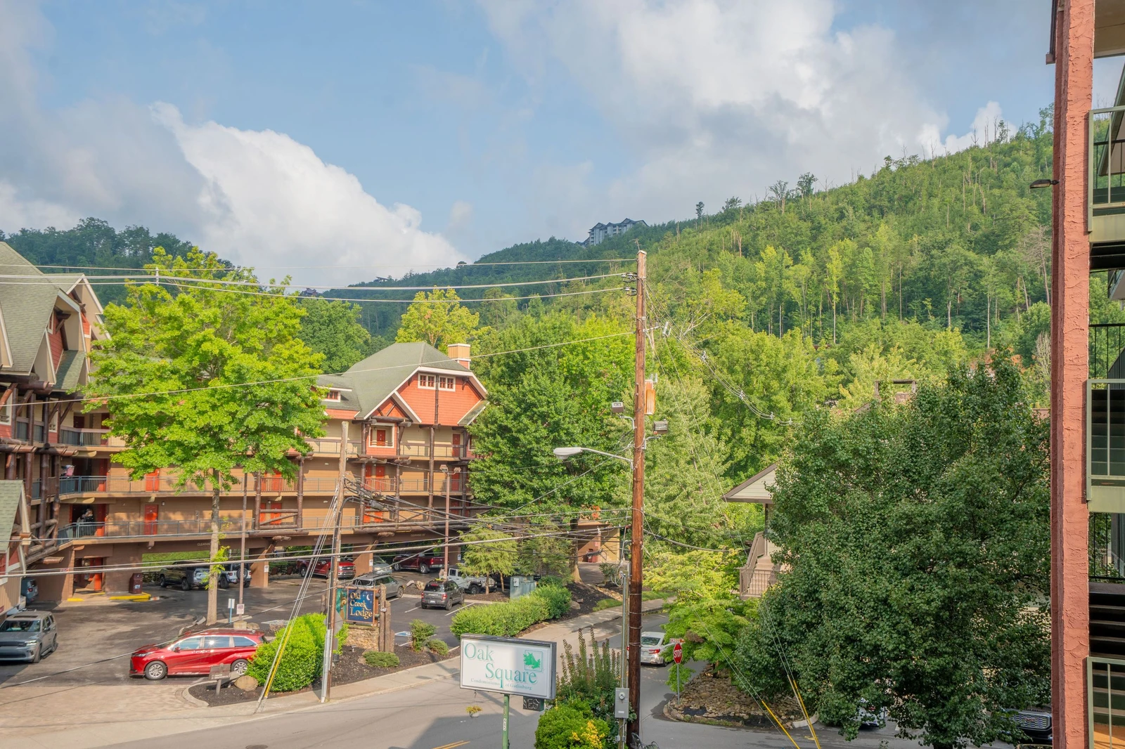 A scenic mountain-town view surrounded by lush green hillsides and neighboring properties, offering a peaceful setting for your getaway.