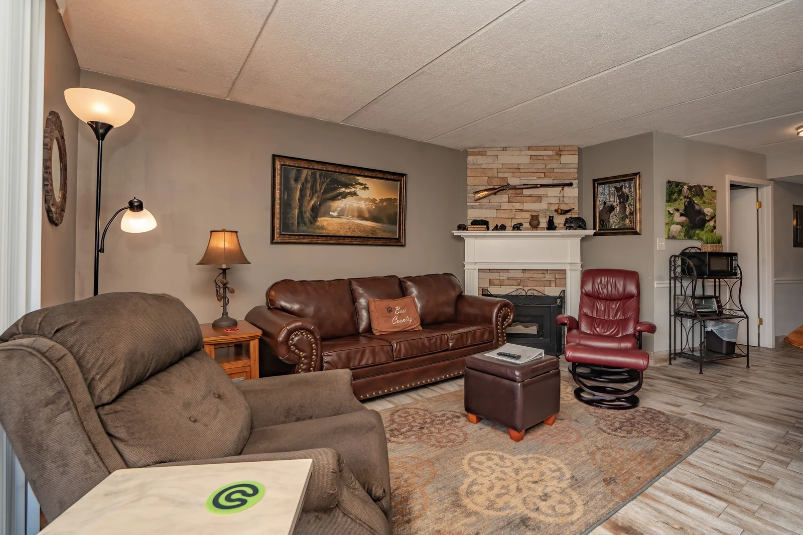 Sink into plush leather seating and let the warmth of the stone fireplace create your perfect retreat—your cozy home base awaits.