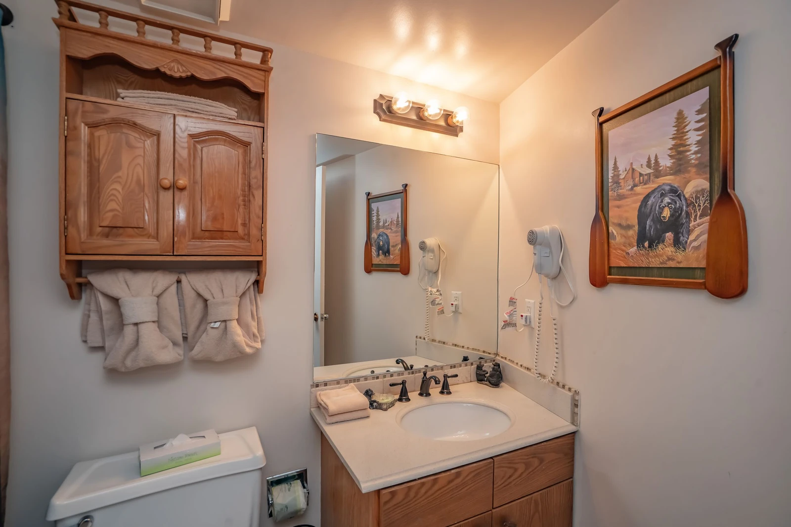 Step into your cozy bathroom with rustic charm and thoughtful touches. Fresh towels and a welcoming vanity await you after a day of adventure.