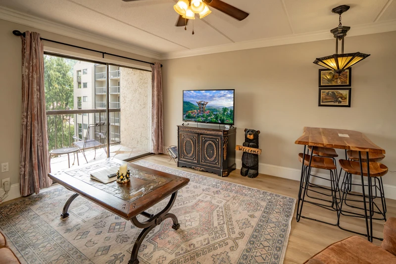 Step into your cozy living area with vaulted ceilings and a private balcony overlooking the neighborhood. Relax with your favorite shows or gather around the bar-height table for good times.