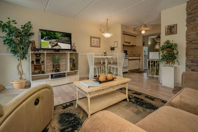 Relax in your warm, inviting living space with cozy seating, natural light, and a fully equipped kitchen just steps away—perfect for unwinding after a day of adventure.