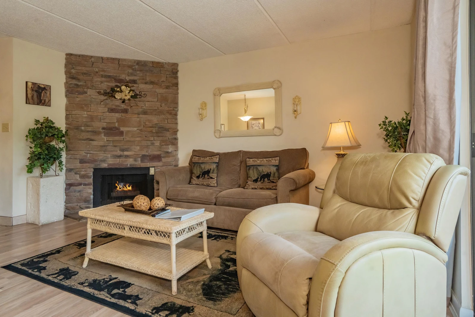 Sink into plush seating by your private fireplace, where rustic stone meets cozy charm. This inviting living room is perfect for unwinding after exploring the area.