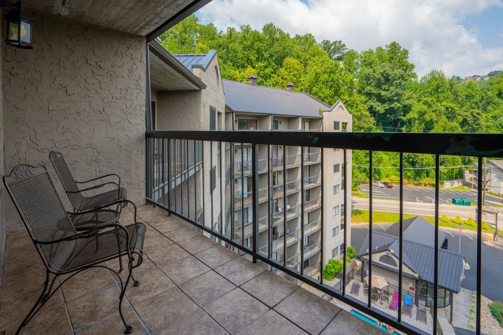 Your balcony overlooks lush hillside scenery and nearby shops, creating a peaceful mountain getaway with convenience just steps away.