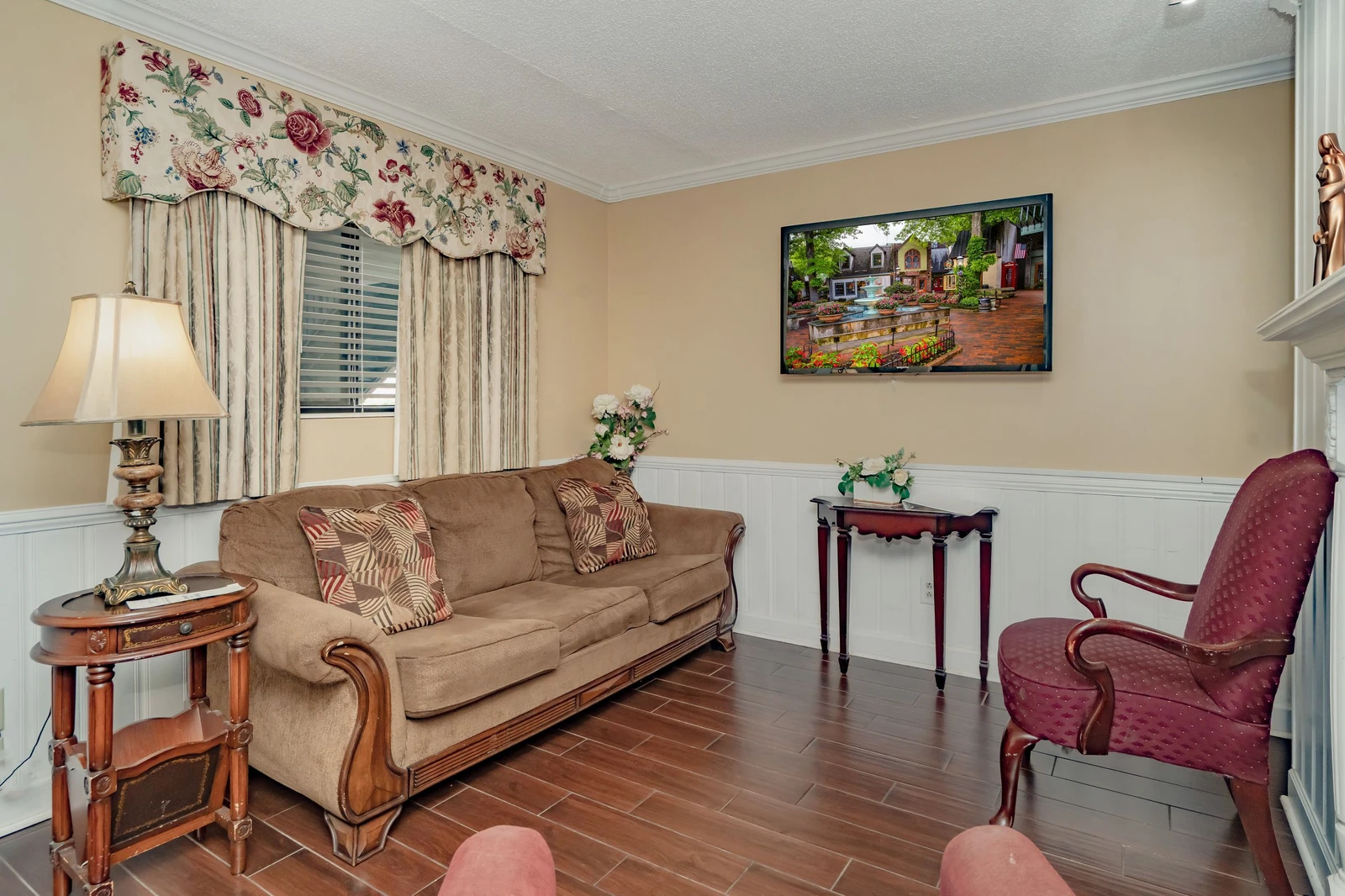 Settle into the cozy living room, where warm tones and classic furnishings invite you to unwind after a day of exploring.