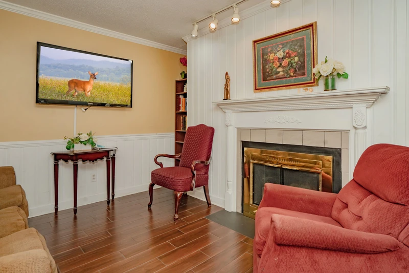 Relax in your cozy living room with a warm fireplace, comfortable seating, and elegant wood floors. Perfect for unwinding after a day of exploration.