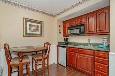 Your cozy kitchenette offers everything you need to prepare light meals or snacks, with warm wood cabinetry, modern appliances, and a charming dining nook for casual breakfasts.