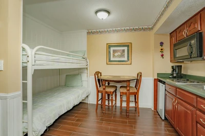 Your cozy retreat blends comfort with convenience—bunk beds for restful nights, a kitchenette ready for your favorite meals, and a charming dining nook where mornings feel a little brighter.