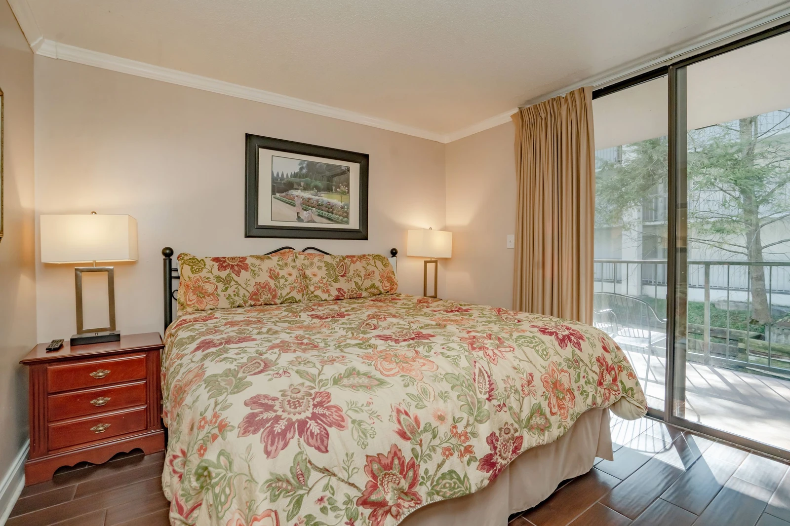 Sink into this comfortable bed dressed in cheerful florals and wake up to natural light streaming through your private balcony doors. Your peaceful retreat awaits.