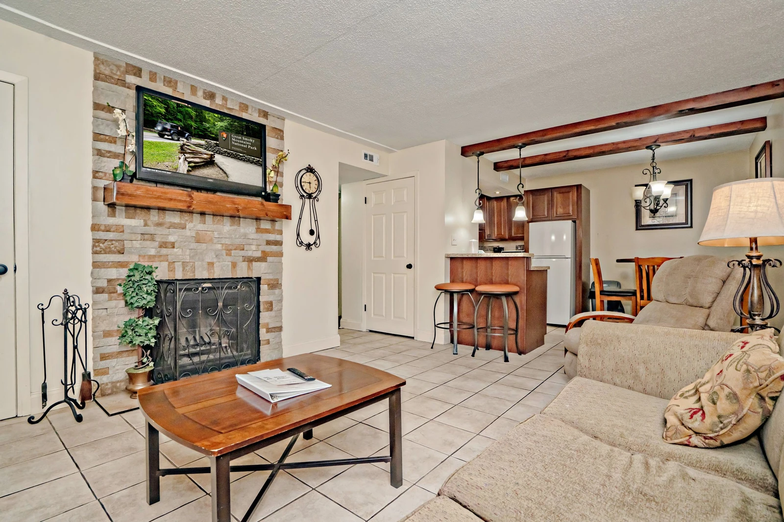 Relax in this inviting living space with a cozy fireplace, comfortable seating, and an open layout flowing into your fully equipped kitchen. Warm wood accents and thoughtful touches make it feel like home.