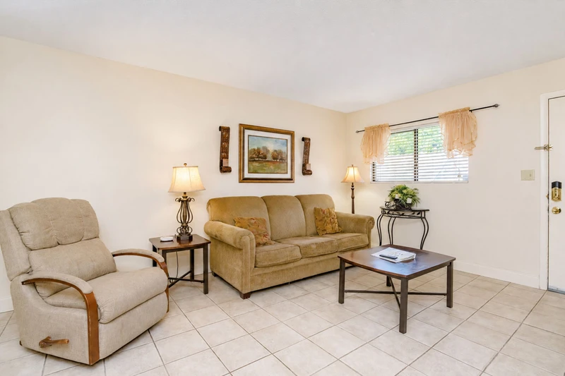 Step into your bright, welcoming living room where natural light spills through soft curtains, and comfortable seating invites you to kick back and unwind after a day of adventure.