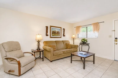 Step into your bright, welcoming living room where natural light spills through soft curtains, and comfortable seating invites you to kick back and unwind after a day of adventure.