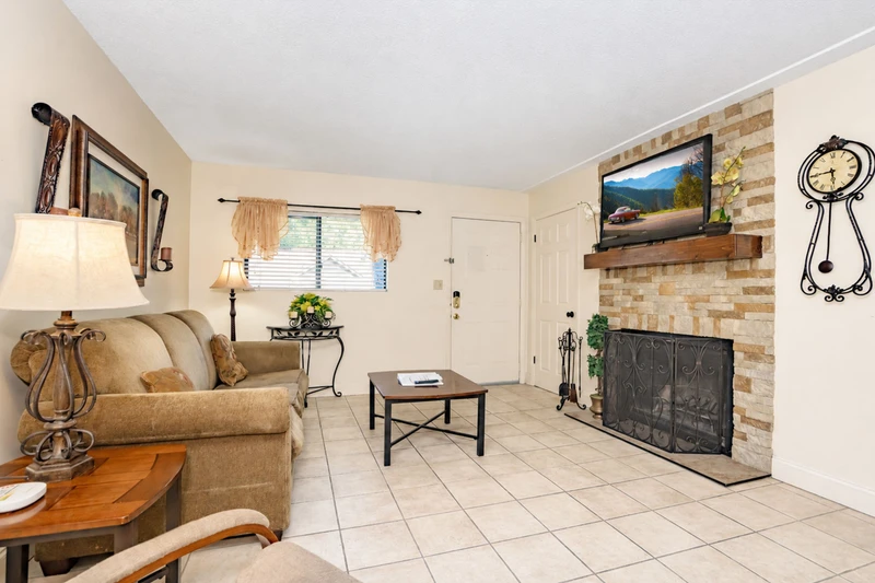 Settle into your inviting living room, where a cozy fireplace and comfortable seating create the perfect retreat after a day of adventure. Natural light fills the space, making it feel warm and welcoming.