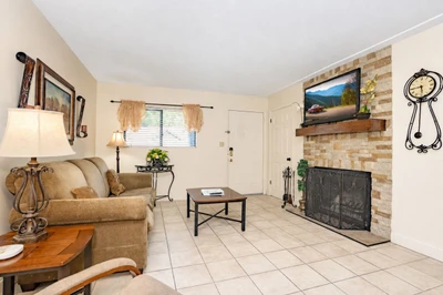 Settle into your inviting living room, where a cozy fireplace and comfortable seating create the perfect retreat after a day of adventure. Natural light fills the space, making it feel warm and welcoming.