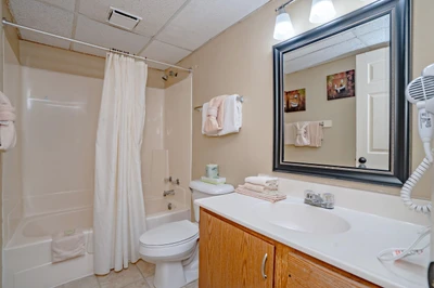 Your spotless bathroom awaits with a fresh shower-tub, crisp linens, and everything you need to refresh after a day of exploring.