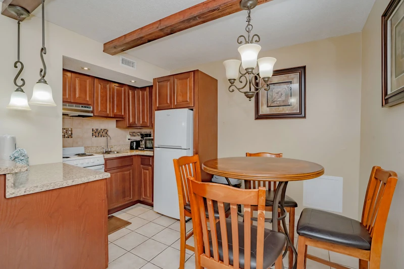 Your inviting kitchen and dining area features warm wood cabinetry, granite counters, and a cozy breakfast nook perfect for morning coffee or evening meals together.