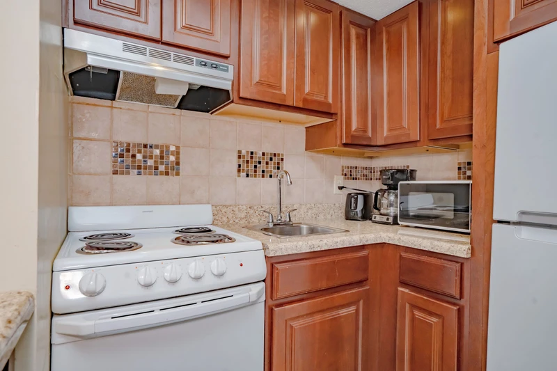 Cook your favorite meals in this well-appointed kitchen, featuring warm wood cabinetry, granite countertops, and everything you need for a comfortable stay.
