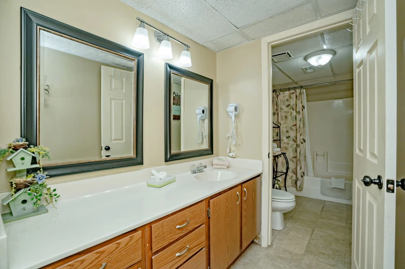 Your private bathroom features dual vanities with ample counter space, bright lighting, and a convenient hair dryer. Everything you need to start your day refreshed and ready.