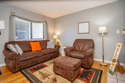 Sink into plush brown leather furniture in your bright, welcoming living room. Hardwood floors and soft natural light create a relaxing retreat where you can unwind after a day exploring.