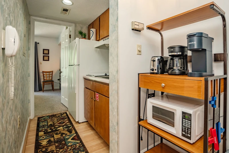 Your kitchenette has everything you need—a full-sized fridge, microwave, coffee station, and a welcoming entrance that leads to the rest of your cozy retreat.