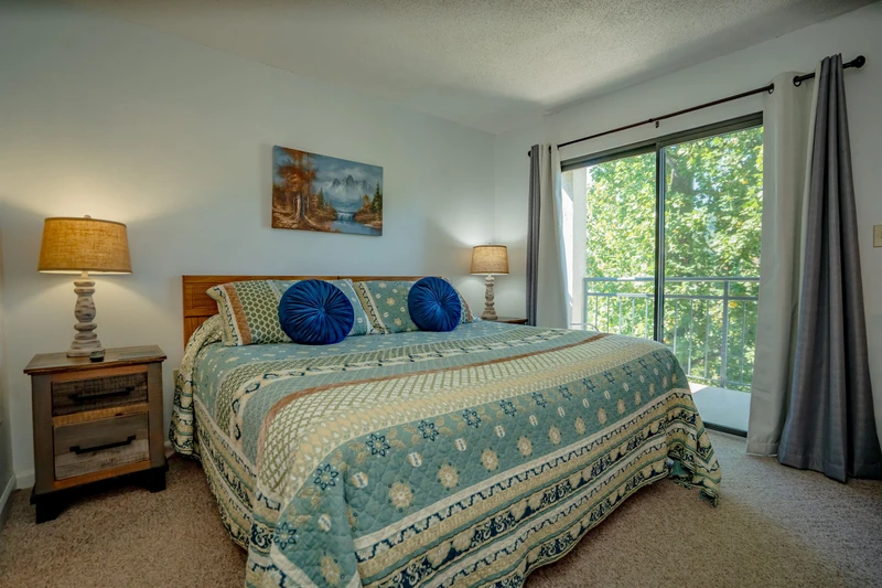 Wake up refreshed in your cozy bedroom, where soothing coastal tones and plush bedding invite you to unwind. Natural light filters through the windows, framing lush green views and welcoming your peaceful mornings.