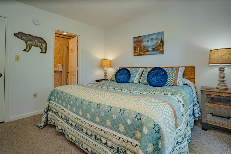 Sink into your cozy mountain retreat bedroom, where soft linens and soothing blue tones promise restful nights after your days of adventure.