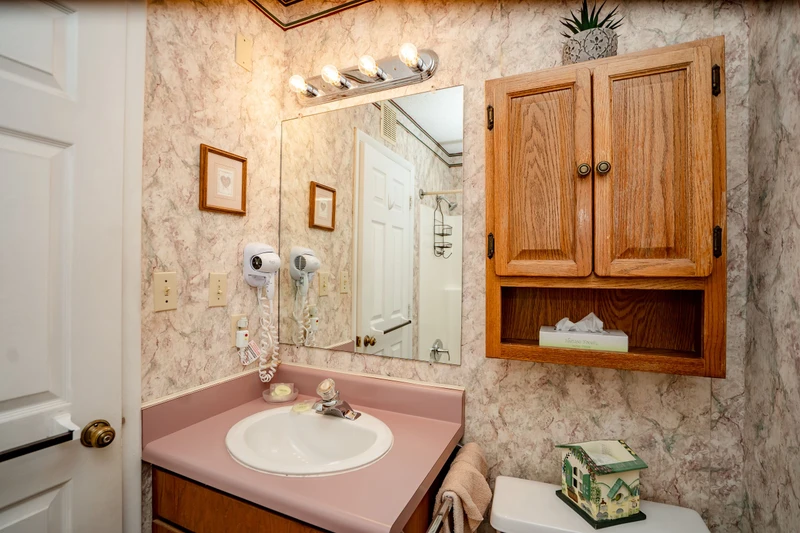 Freshen up in your private bathroom with a convenient vanity, well-lit mirror, and plenty of storage. You'll find everything you need within easy reach for a comfortable stay.