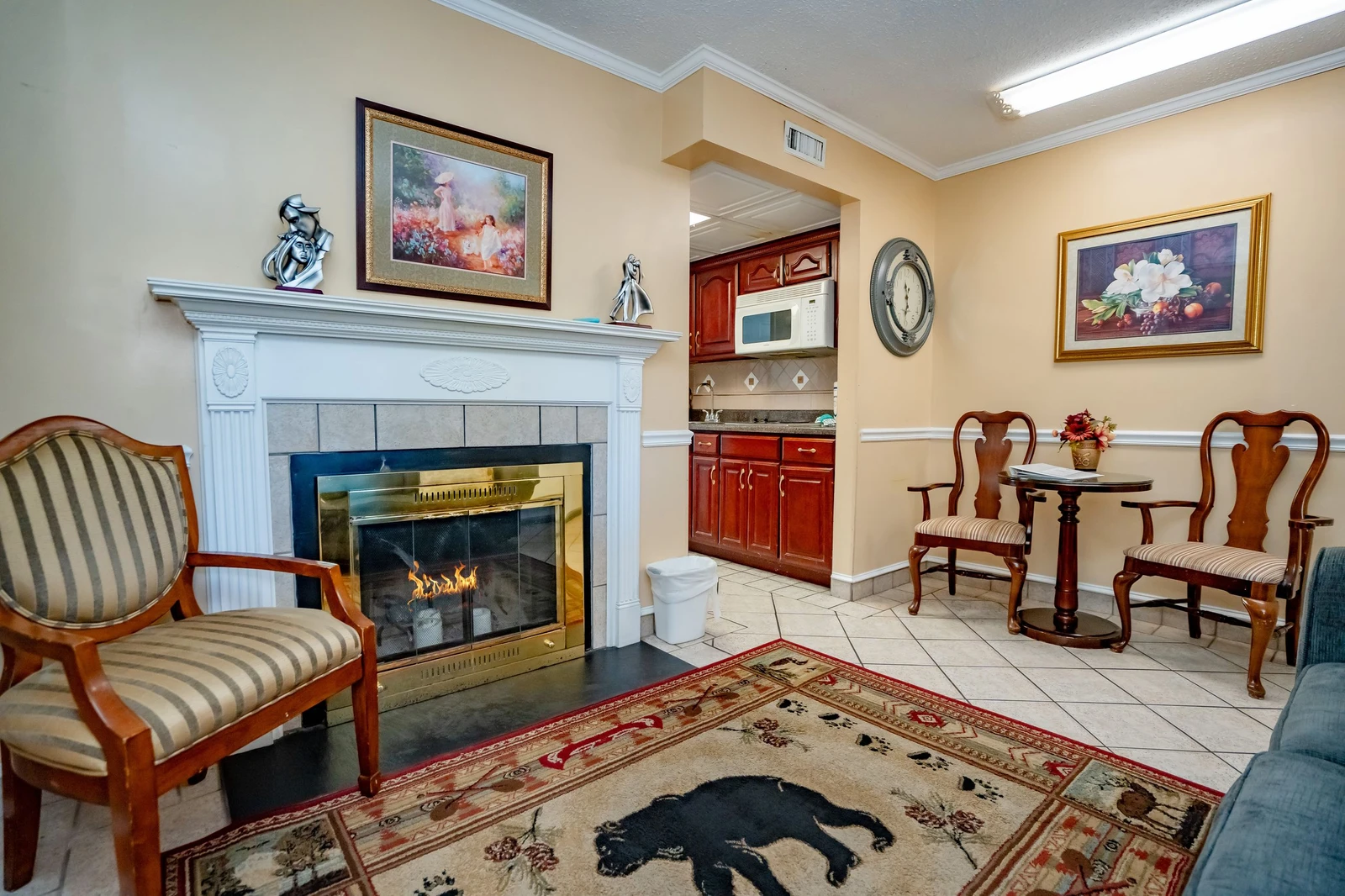 Settle into this inviting living space, where a warm fireplace creates the perfect ambiance and a cozy kitchenette awaits your morning coffee.