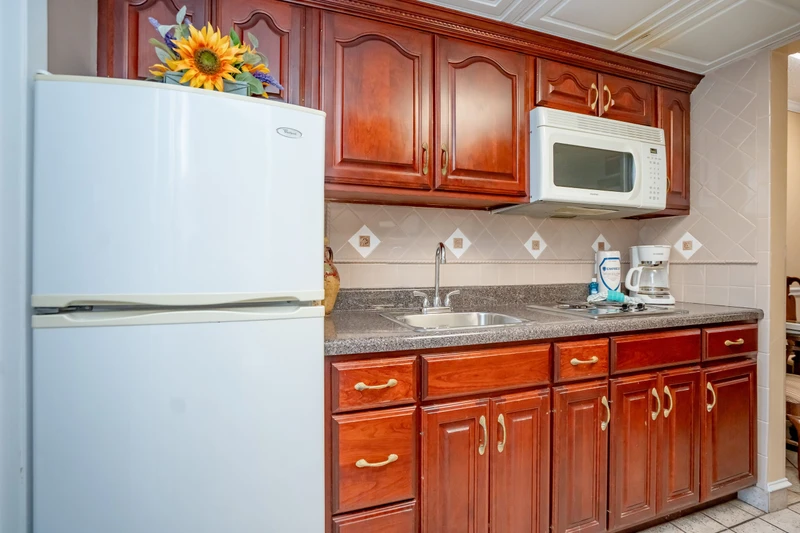 Your fully equipped kitchen features rich wood cabinetry, granite counters, and everything you need to whip up your favorite meals. The microwave, coffee maker, and ample storage make it easy to feel right at home.