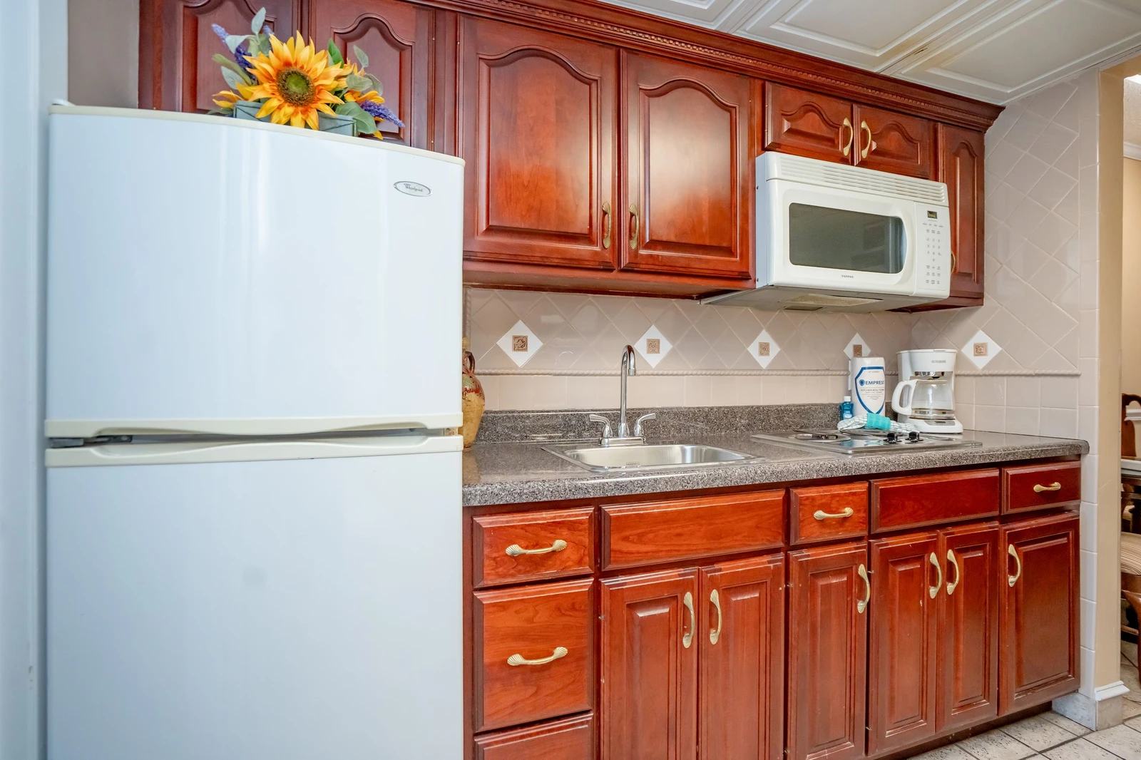 Your fully equipped kitchen features rich wood cabinetry, granite counters, and everything you need to whip up your favorite meals. The microwave, coffee maker, and ample storage make it easy to feel right at home.