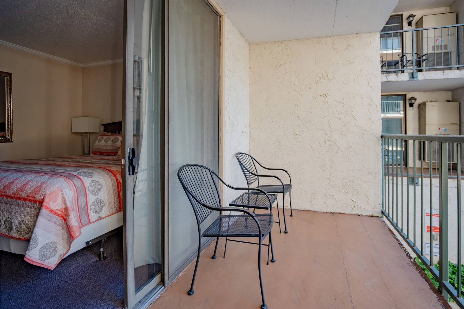 Step onto your private balcony where two cozy chairs await your morning coffee or evening unwind. This quiet outdoor space overlooks the surrounding area, offering you a peaceful retreat right outside your bedroom.