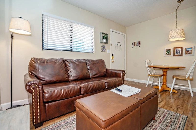 Sink into this inviting leather sofa and unwind in your own cozy living space, where warm lighting and thoughtful touches create the perfect atmosphere for relaxation after a day of exploring.