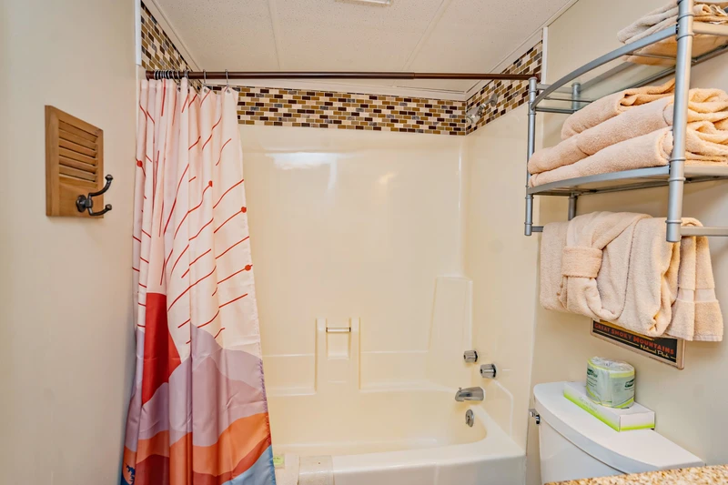 Step into your spa-like bathroom with a deep soaking tub and elegant mosaic tile accents. Fresh towels and thoughtful touches await your arrival.