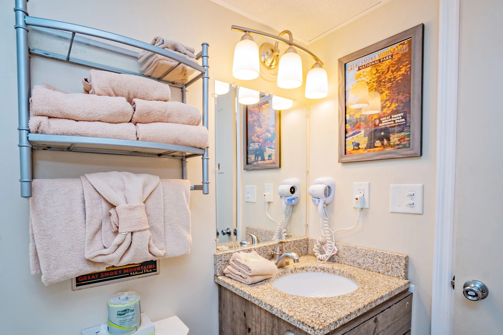 Fresh towels await your arrival in this welcoming bathroom, where thoughtful touches like a hairdryer make settling in effortless and easy.