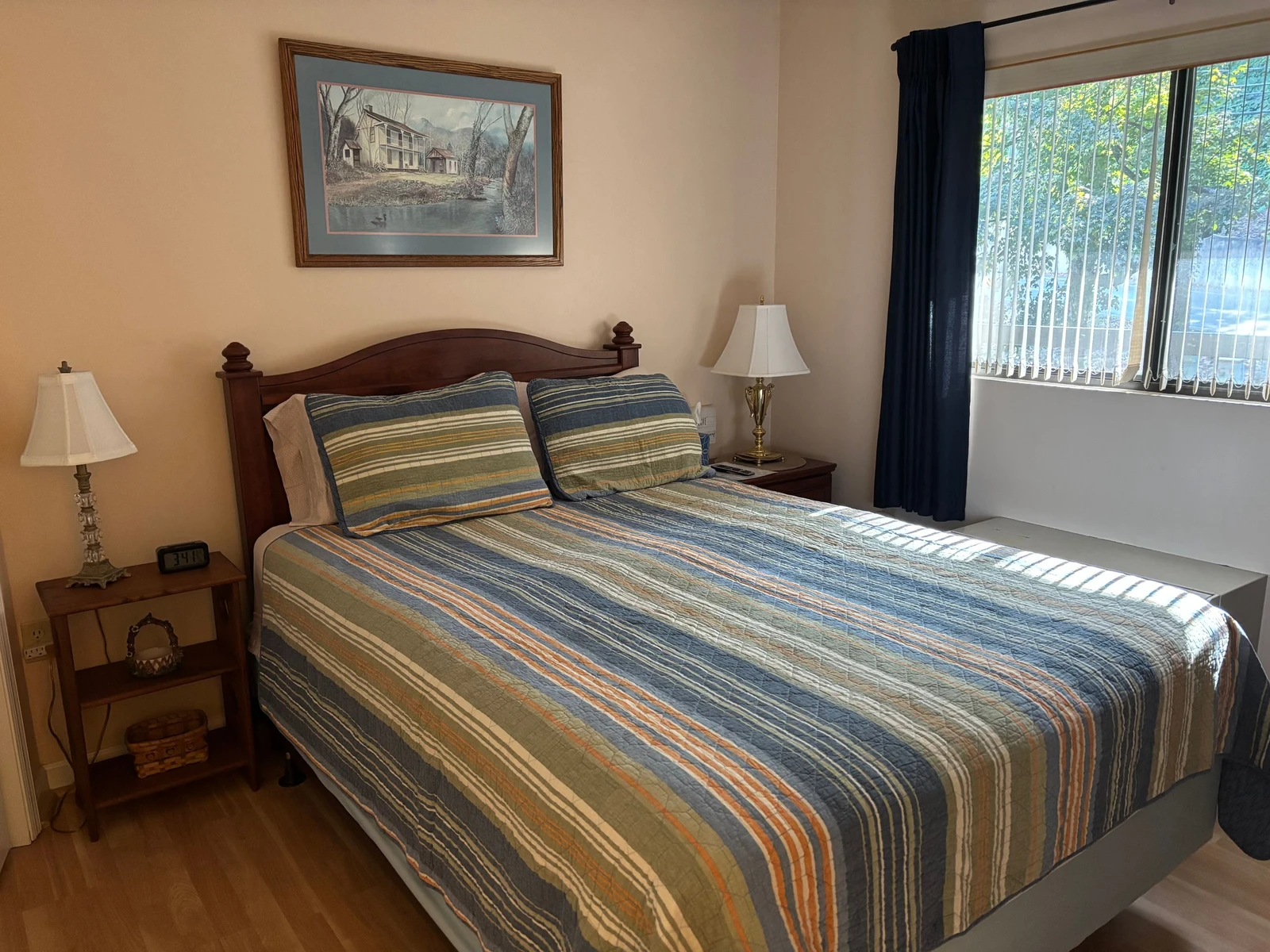 Rest easy in this peaceful bedroom, where comfortable linens and natural light create your perfect retreat after a day of adventure.