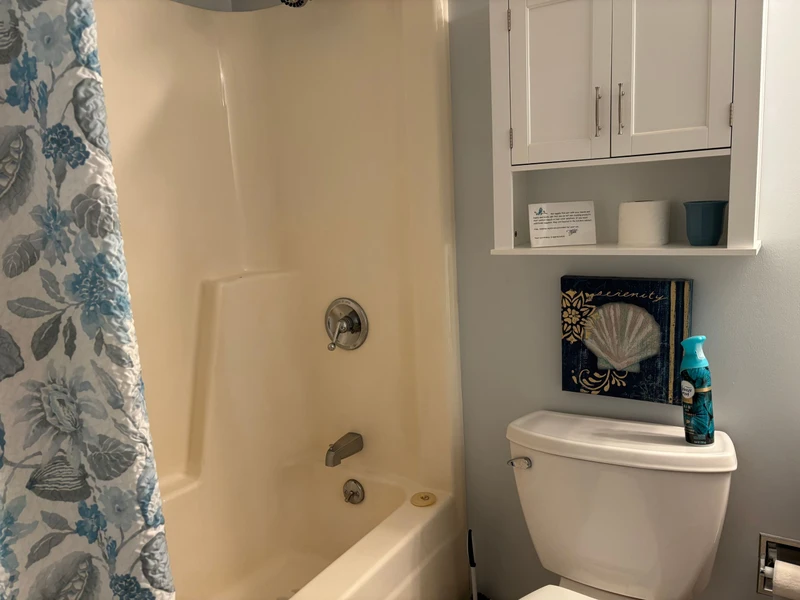 Your private bathroom features a tub-shower combo and crisp white cabinetry for all your essentials—perfectly designed for your comfort and convenience.